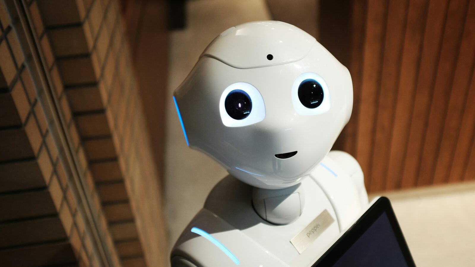 A humanoid service robot holding a tablet